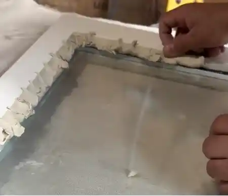 Traditional linseed oil putty glazing on a period window